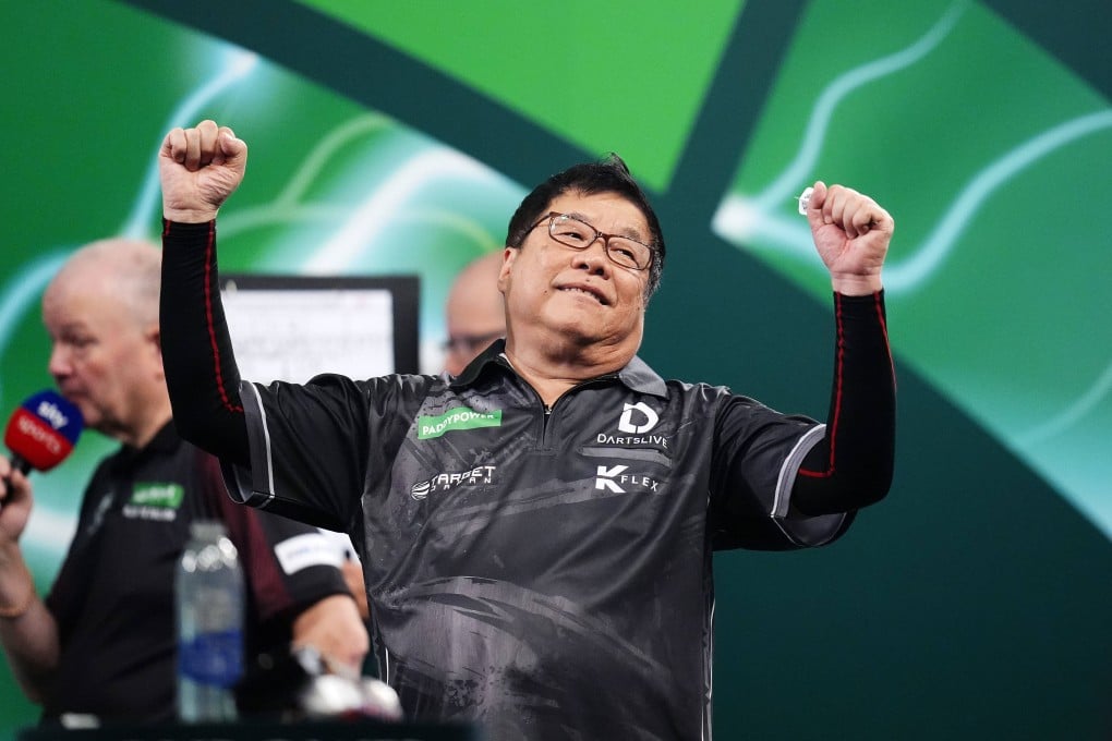 Paul Lim celebrates beating Jeffrey de Graaf on day three of the World Darts Championship. Photo: AP