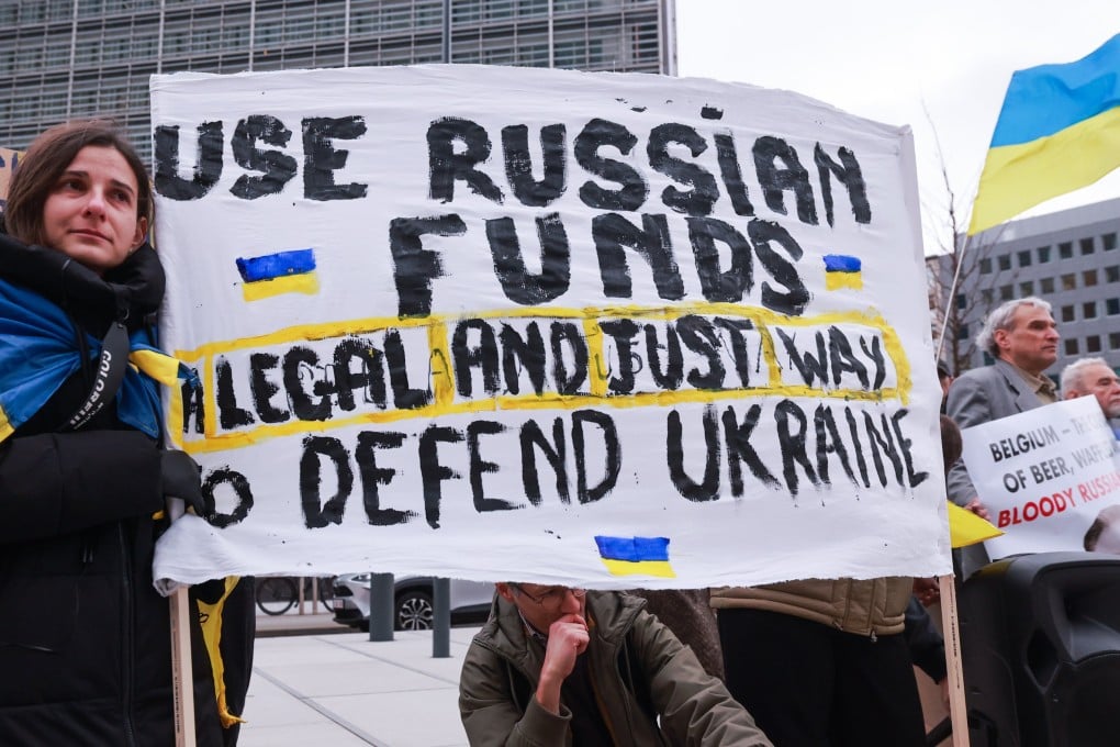 Ukrainians hold placards during a protest demanding the use of frozen Russian assets, on the sidelines of the Economic and Financial Affairs Council (ECOFIN) meeting in Brussels, Belgium, December 12, 2025. Photo: EPA