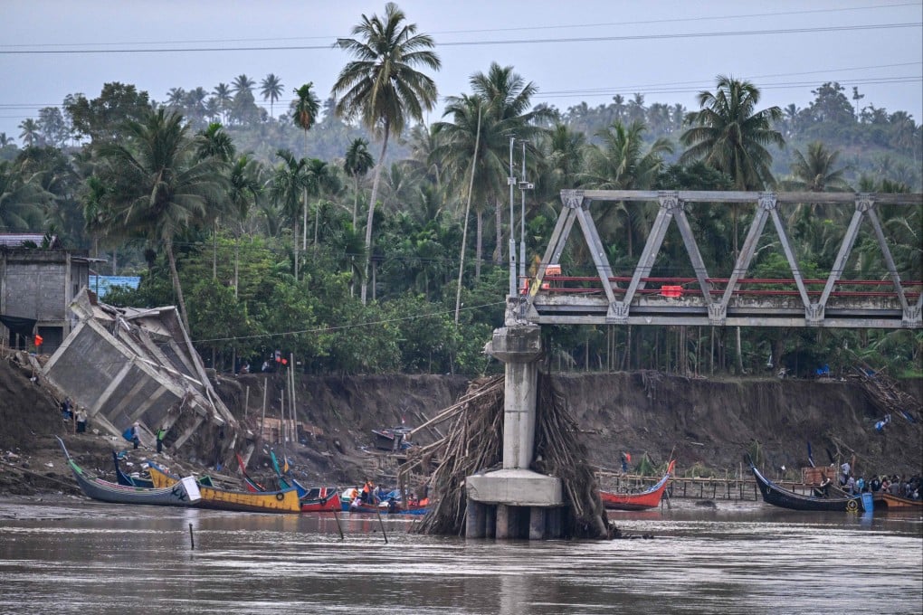 Boats used to ferry passengers across a river are seen near a collapsed bridge in Indonesia’s Aceh province in the aftermath of deadly flash floods this month. Photo: AFP