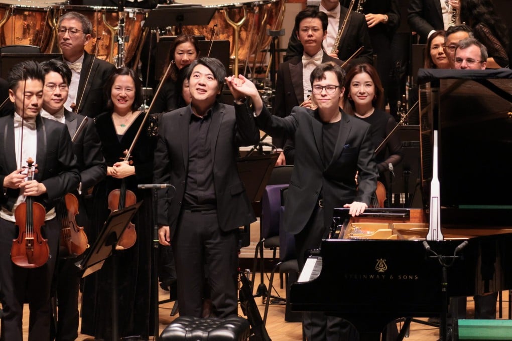 Finnish conductor Tarmo Peltokoski (centre right) raises his hand with Chinese pianist Lang Lang on stage with the Hong Kong Philharmonic Orchestra at the Hong Kong Cultural Centre on December 11, 2025. Photo: HK Phil