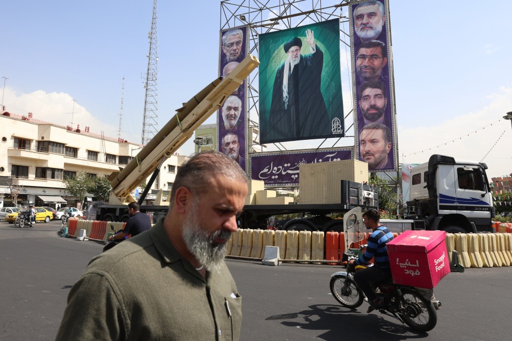 An Iranian medium-range ballistic missile is seen next to a large banner depicting the country’s Supreme leader Ayatollah Ali Khamenei, in the capital Tehran. Photo: EPA
