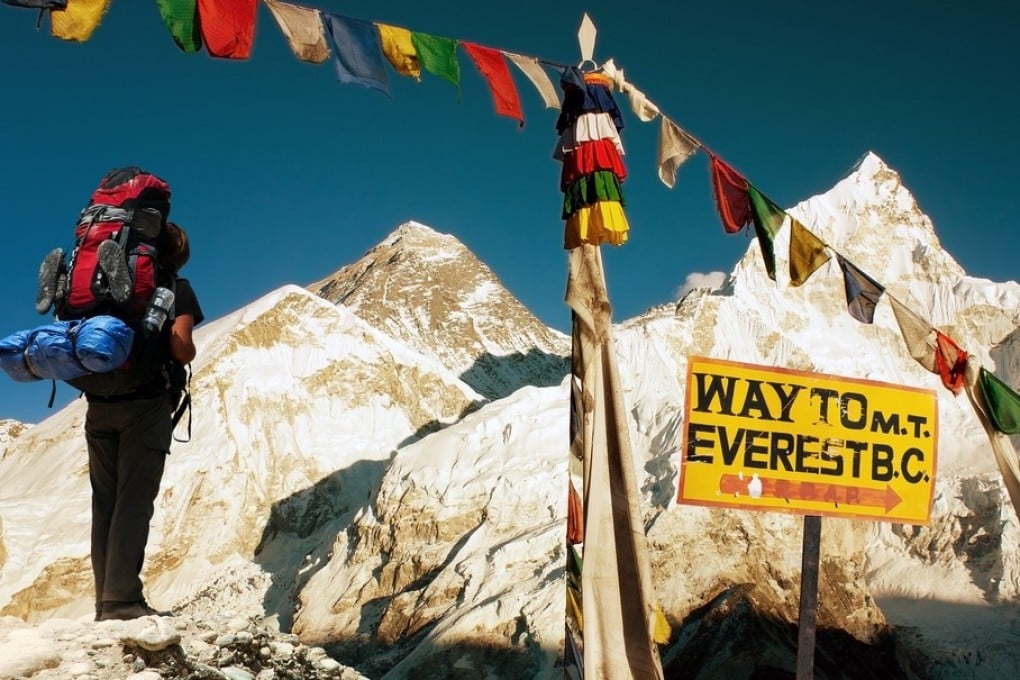 A tourist admires the view of Mount Everest from Kala Patthar, Nepal. Photo: Shutterstock