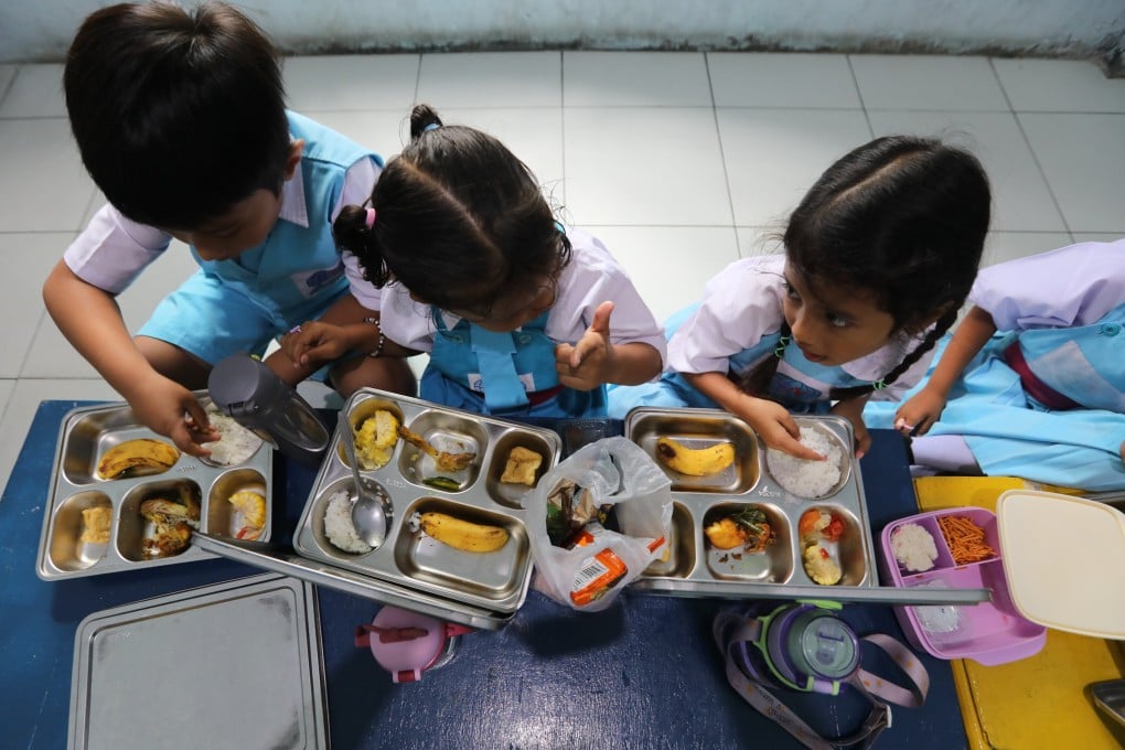 Indonesian students eat a free school meal in Aceh Besar earlier this year. Photo: EPA