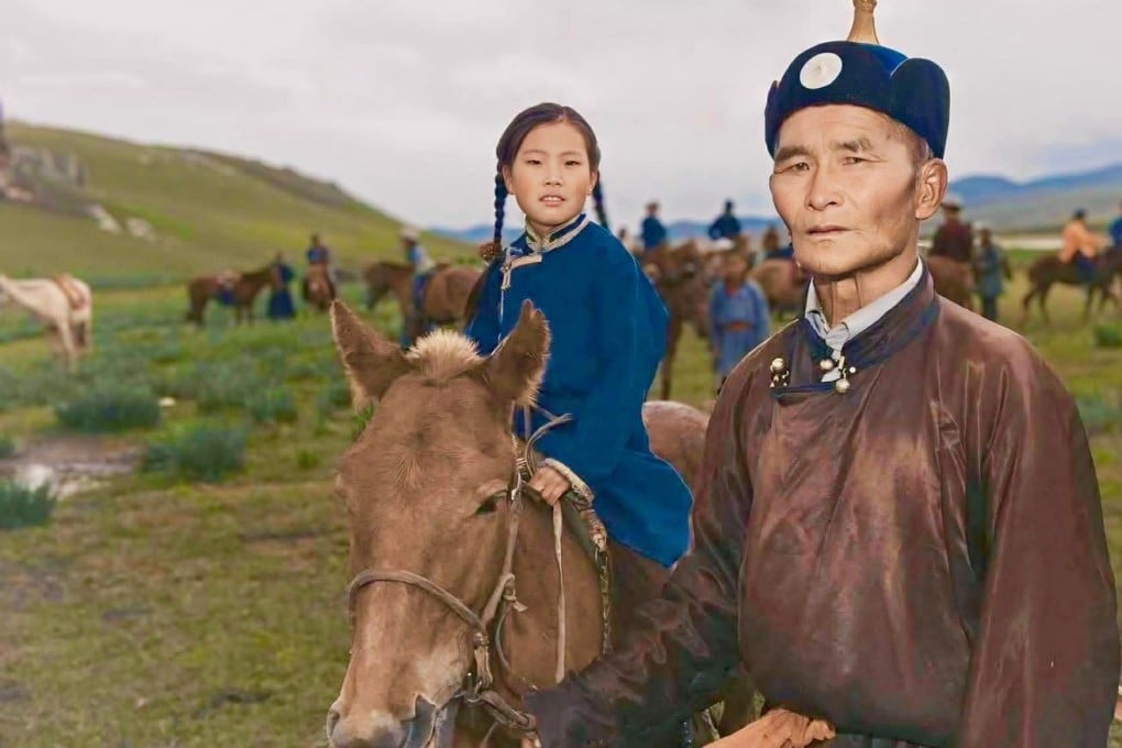 Horse rider Dolgorsuren Batoyun (centre) is pictured as a child. Now grown up, the first woman member of Mongolia’s national polo team looks back fondly on the “cultures and customs” her father (right) taught her. Photo: Dominique Backhouse