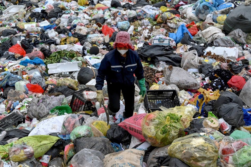 A woman picks up plastic waste at a landfill on the outskirts of Hanoi, Vietnam. Photo: AFP
