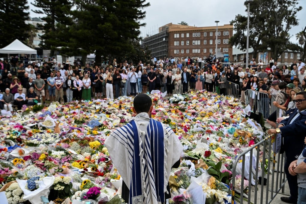 People attend a floral memorial in honour of the Bondi Beach shooting victims in Sydney on Tuesday. Photo: Reuters