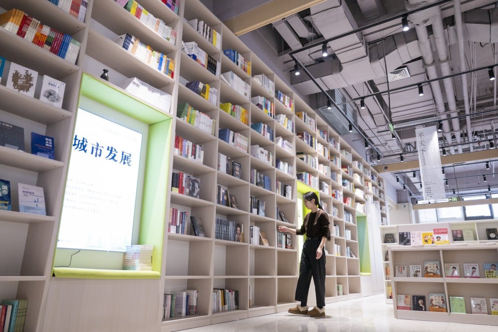 A staff member arranges books at a book shop in Hebei province’s Xiongan New Area last month. Photo: Xinhua