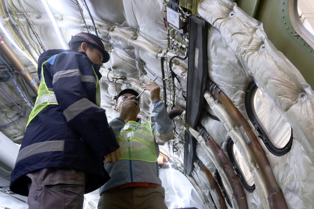 Instructor Martin Law (right), who was trained at Elior’s base in France, works with a trainee on an aircraft electrical supply system. Photo: Jonathan Wong