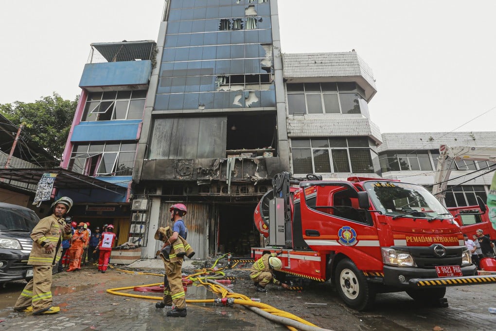 Firefighters at a building in central Jakarta where a fire killed 22 people on December 9. Photo: TNS