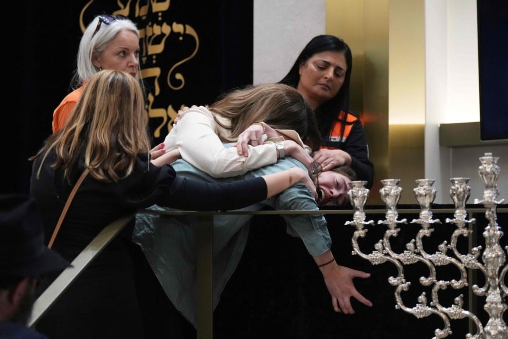 Family members react at the coffin of Rabbi Eli Schlanger, a victim in the Bondi Beach shooting, during his funeral at a synagogue in Sydney on Wednesday. Photo: AFP