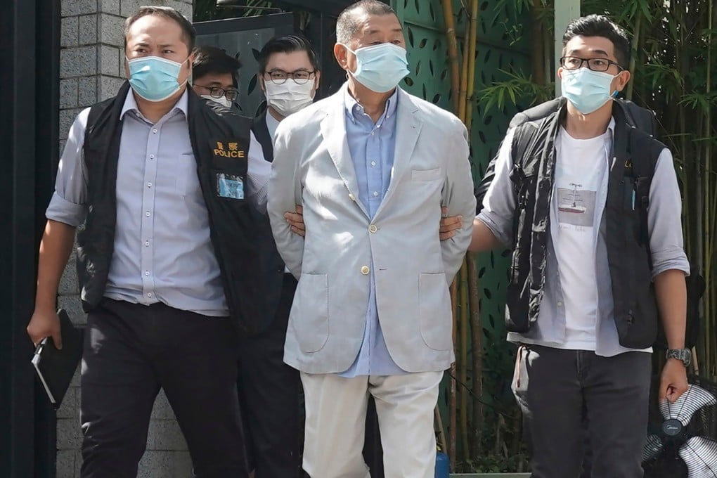 Jimmy Lai, centre, is arrested by police officers at his home on August 10, 2020. Photo: AP