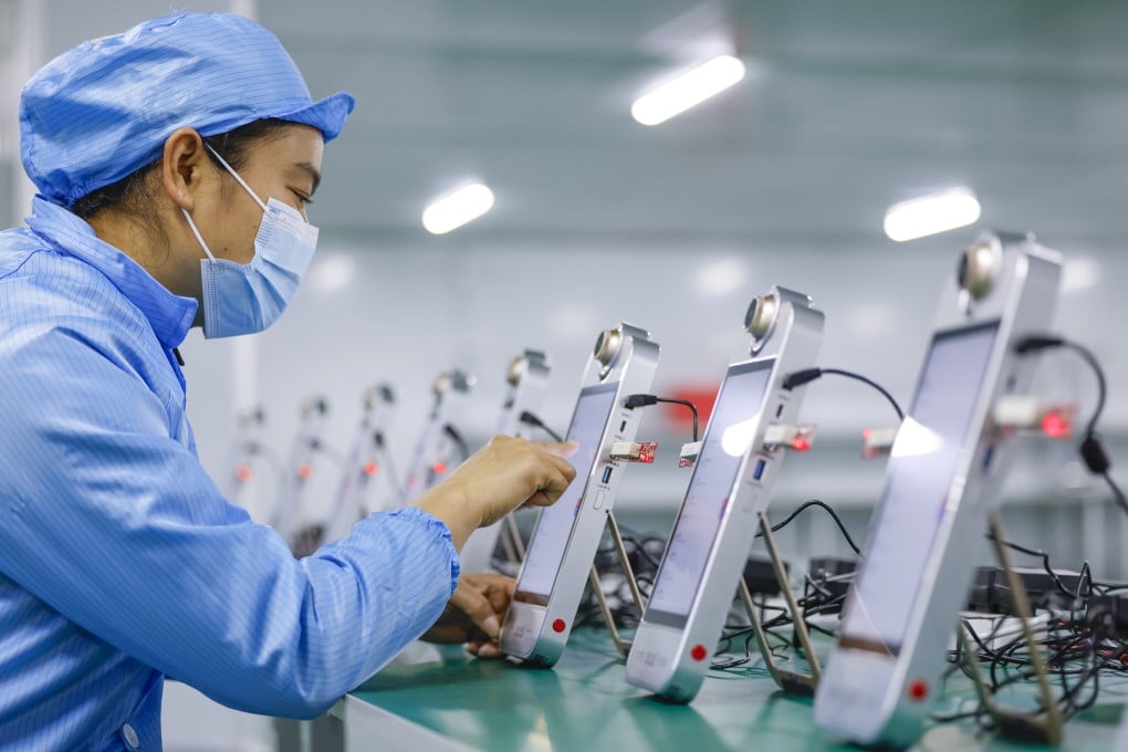 An employee debugs the AI-powered live-streaming machines at a Rexso workshop on December 8 in Huangshan in China’s Anhui province. Photo: VCG via Getty Images