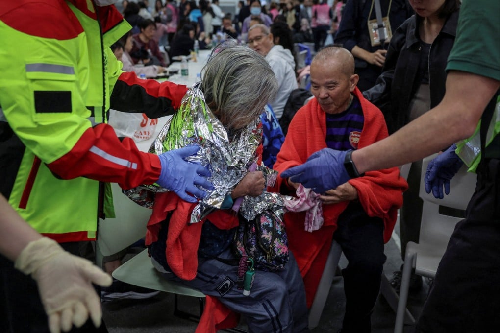 A woman receives medical attention at a temporary shelter, after a fire started across multiple buildings at Wang Fuk Court housing estate in Hong Kong’s Tai Po district on November 26. Photo: Reuters