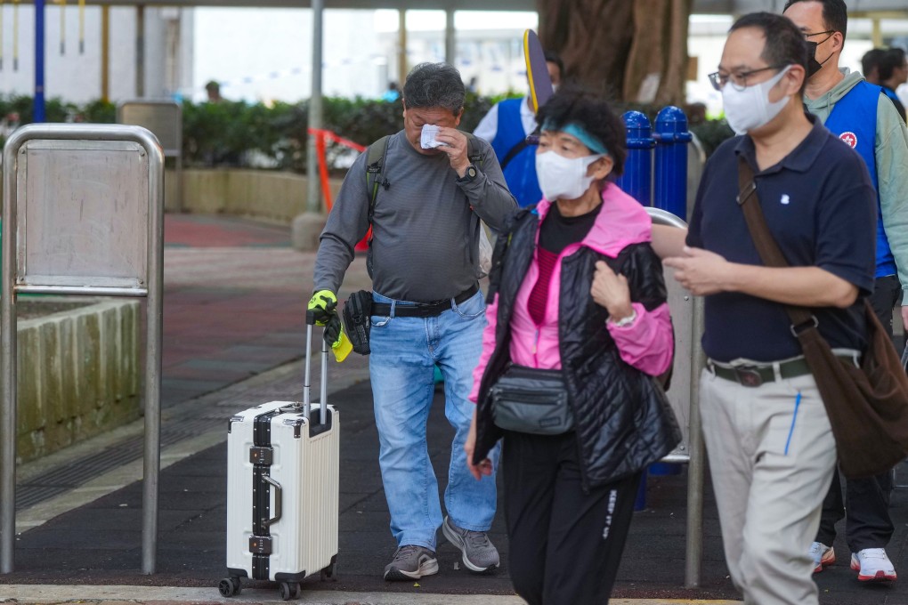 Residents of Wang Chi House, the only tower spared from the fire, were allowed to allowed to return home to collect their belongings. Photo: Sam Tsang