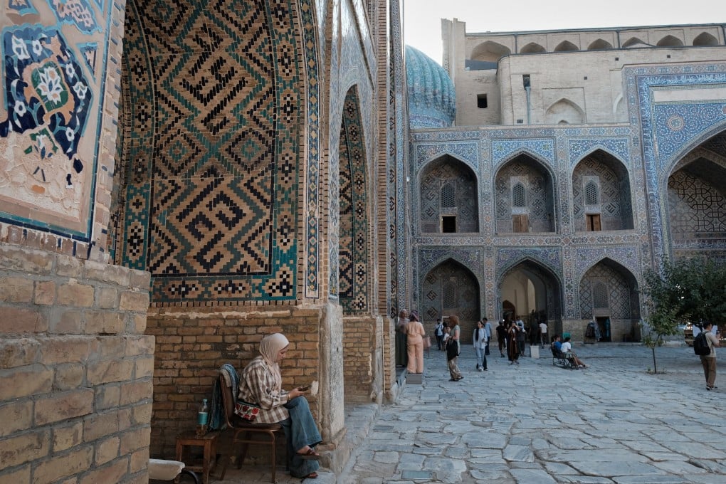 Vendors sell traditional Uzbek clothing and jewellery inside a madrasah in Registan Square in Samarkand, Uzbekistan In September. Photo: EPA