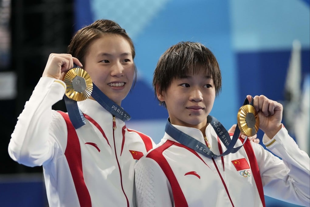 China’s Chen Yuxi (left) and Quan Hongchan hold their gold medals after winning the women’s synchronised 10m platform diving at the 2024 Summer Olympics. Photo: AP