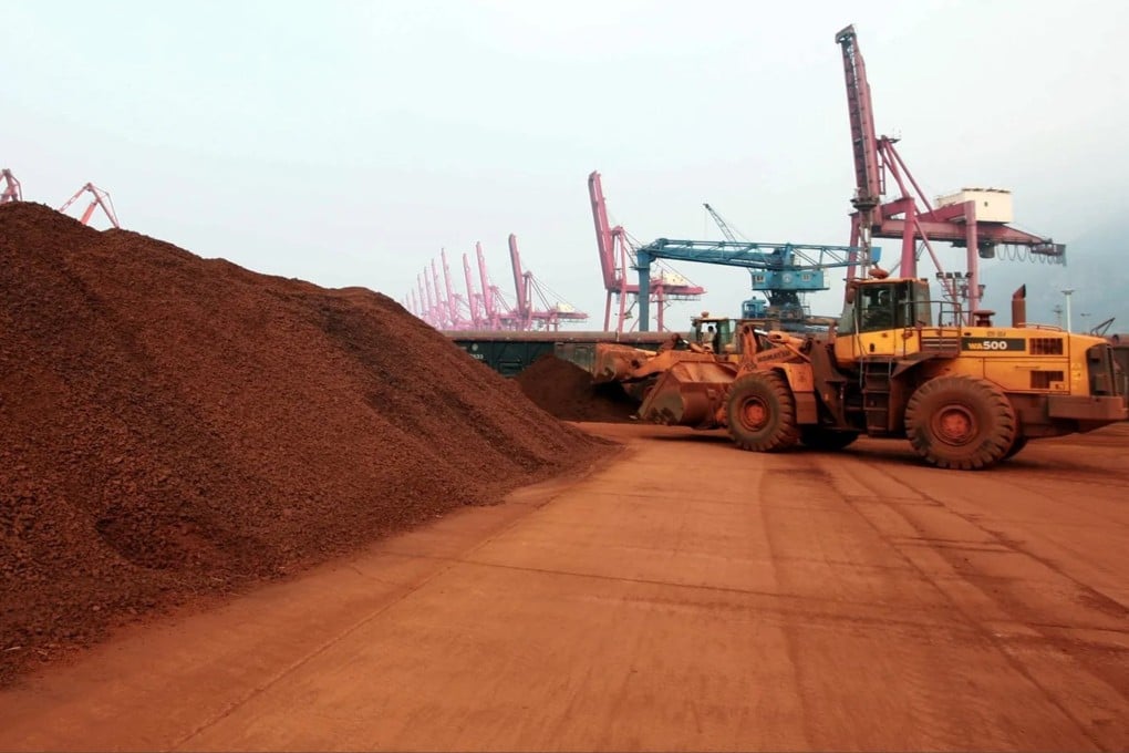 A worker shifts soil containing rare earth minerals to be loaded for export at a port in China’s eastern Jiangsu province. Photo: AFP