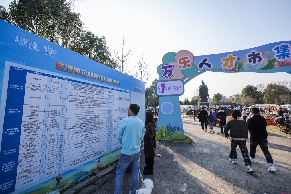 A man checks out job listings at a farmers’ fair in Jiande, Zhejiang province, on December 6. Photo: Xinhua