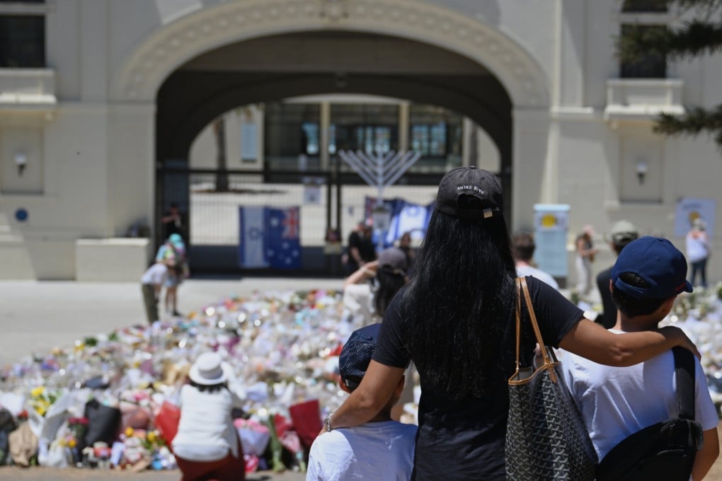 People visit a floral tribute outside the Bondi Pavilion on Friday following Sunday’s shooting. Photo: AP