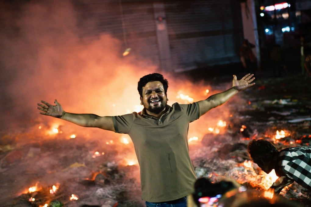 A protester reacts to the camera near the offices of the Prothom Alo newspaper, which were set on fire by angry protesters in Dhaka on Friday. Photo: AP