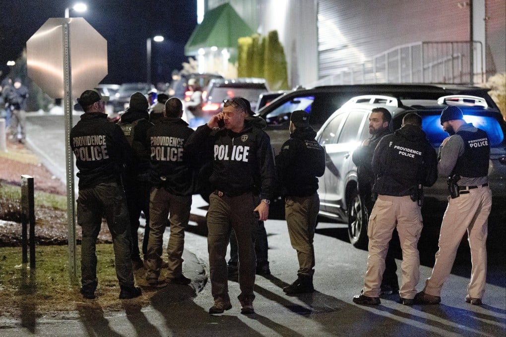 Providence Police Officers join state and federal law enforcement agents searching for the Brown University shooter, in Salem, New Hampshire. Photo: Reuters