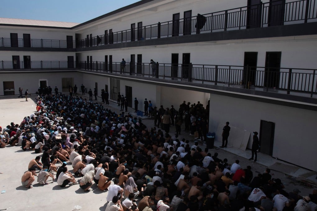 People from China, Vietnam, and Ethiopia – believed trafficked and forced to work in scam centers – sit masked in detention after their February release in Myawaddy, eastern Myanmar. Photo: AP