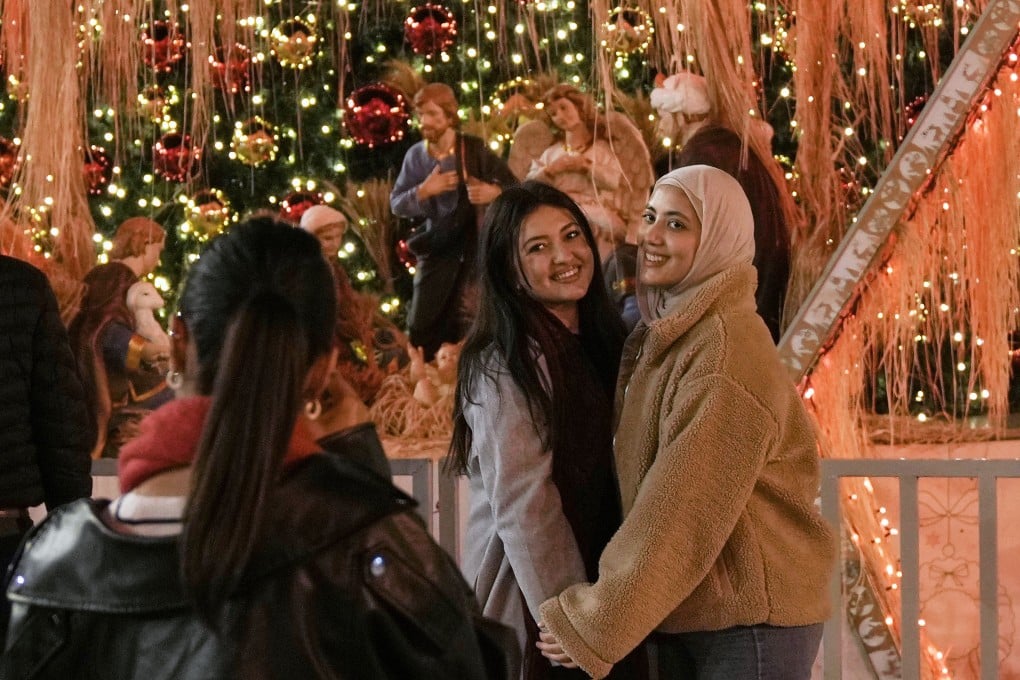 Women pose for a picture in Manger Square in the West Bank city of Bethlehem on Tuesday. Photo: AP