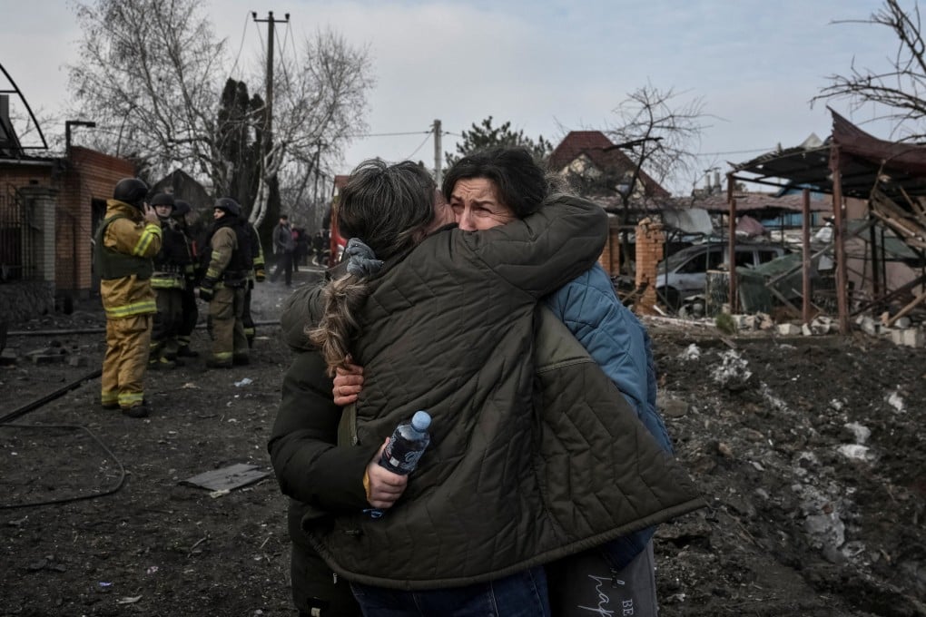 Residents react at the site of a Russian air strike in Zaporizhzhia, Ukraine, on Friday. Photo: Reuters