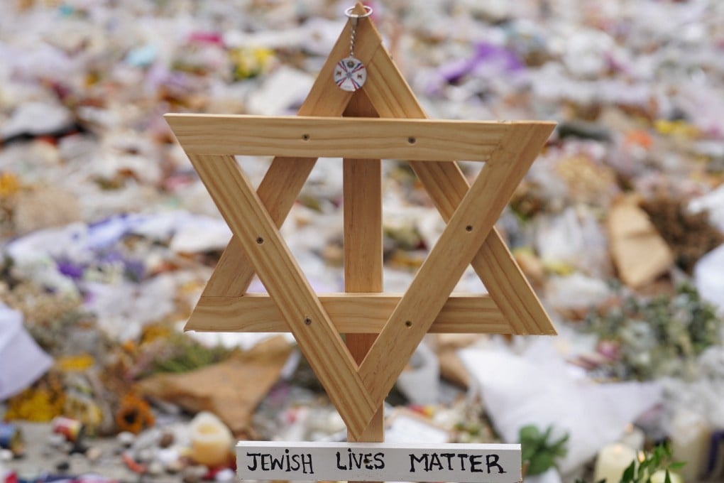 A wooden Star of David stands in a makeshift memorial to pay tribute to the victims of Sunday’s mass shooting on Bondi Beach. Photo: Reuters