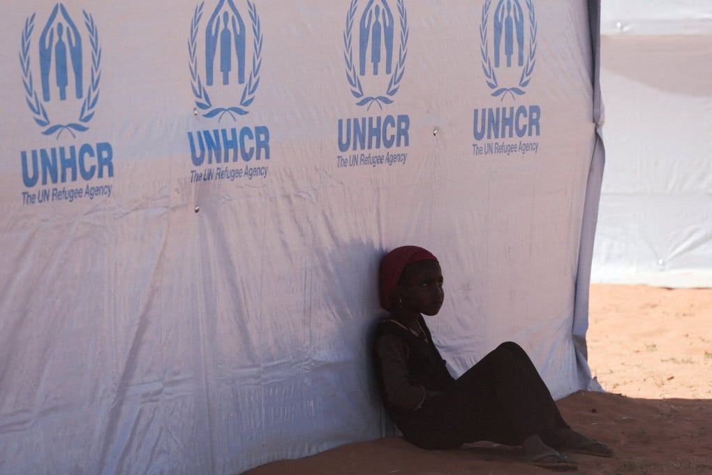 A Sudanese refugee girl from Darfur rests beside a United Nations High Commissioner for Refugees (UNHCR) tent inside the Touloum refugee camp, on the outskirts of the town of Iriba in Wadi Fira province, eastern Chad, on November 30. Photo: Reuters