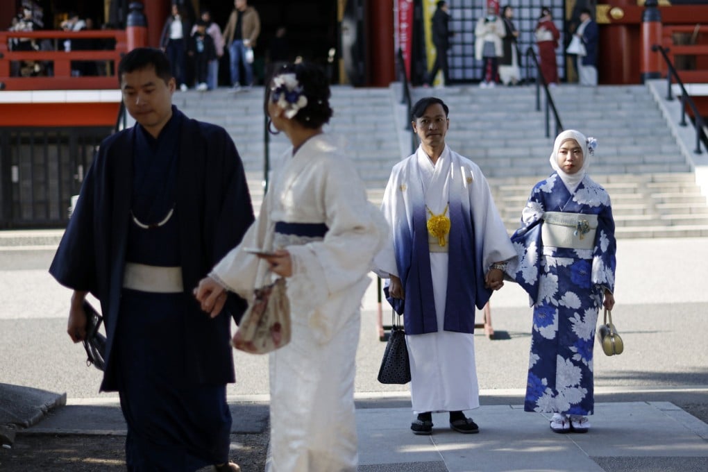 Visitors don traditional outfits to visit the Sensoji Temple at Asakusa district in Tokyo on Friday. Photo: EPA