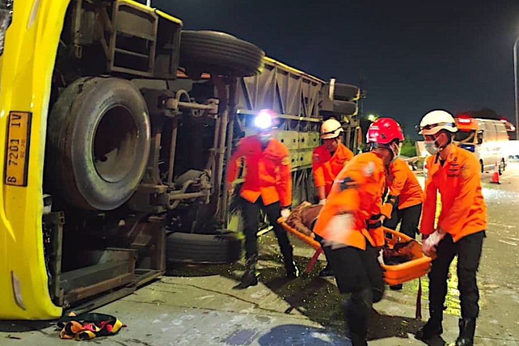 Rescuers carry a survivor from the wreckage of a crashed bus in Semarang, Central Java, on Monday. Photo: Basarnas/EPA