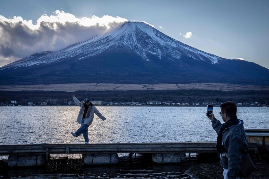 Visitors take photos against the backdrop of Japan’s Mount Fuji. Tensions have been high between China and Japan since November. Photo: AFP