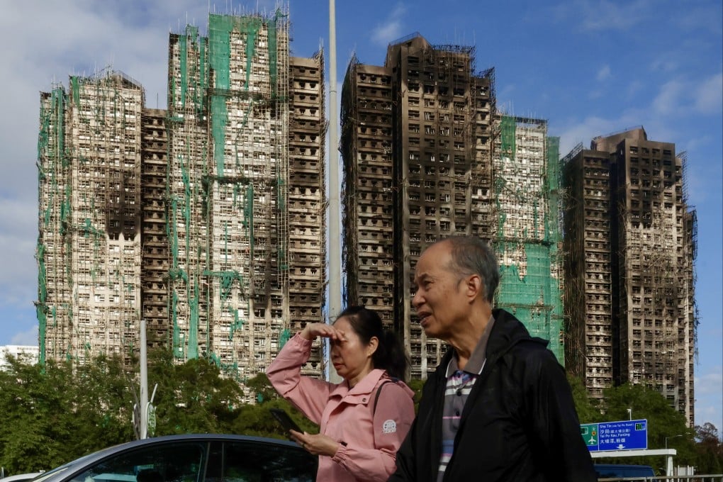 People walk past Wang Fuk Court in Tai Po, on December 20, weeks after a deadly fire burned the community and at least claimed 161 lives. Photo: Jonathan Wong