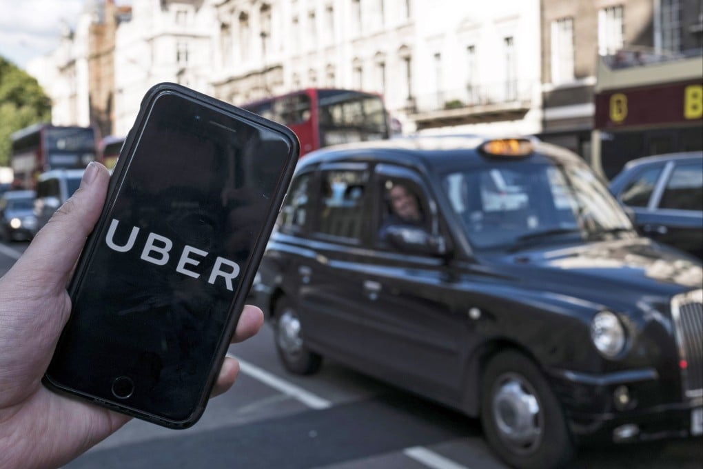 An arranged image shows the Uber logo on a mobile phone in central London. Photo: EPA-EFE
