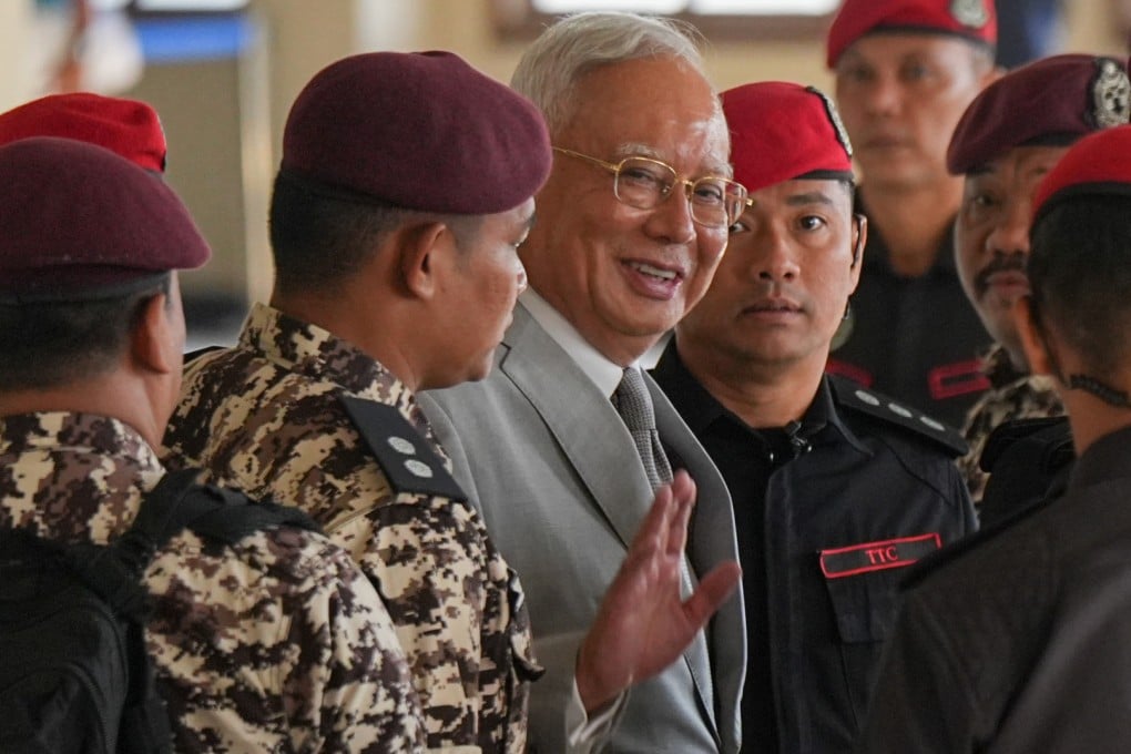 Former Malaysian prime minister Najib Razak is escorted by prison officers on his arrival at the Kuala Lumpur High Court Complex on Monday. Photo: AP