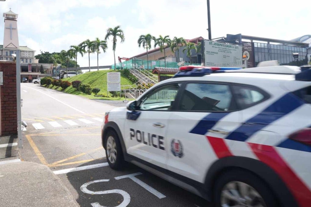 A Singapore police car drives into St Joseph’s Church, where a man reported a bomb threat. Photo: Facebook/Singapore Police Force
