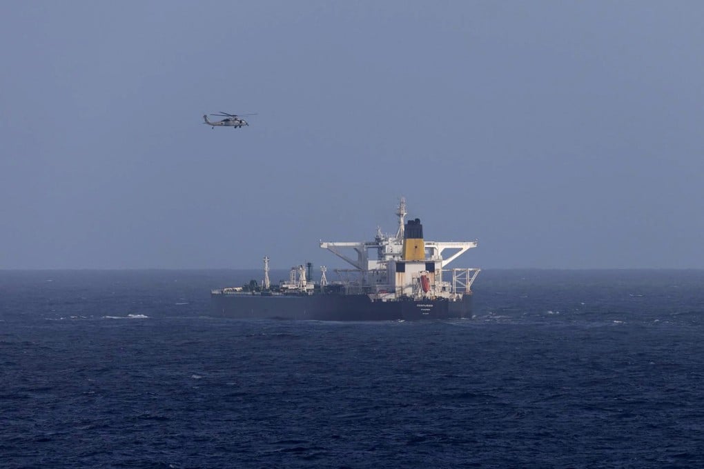A US military helicopter flies over the Panama-flagged Centuries, which was intercepted by the US Coast Guard on Saturday. On Sunday, officials said the US was pursuing a third tanker in waters off Venezuela. Photo: DHS via Reuters