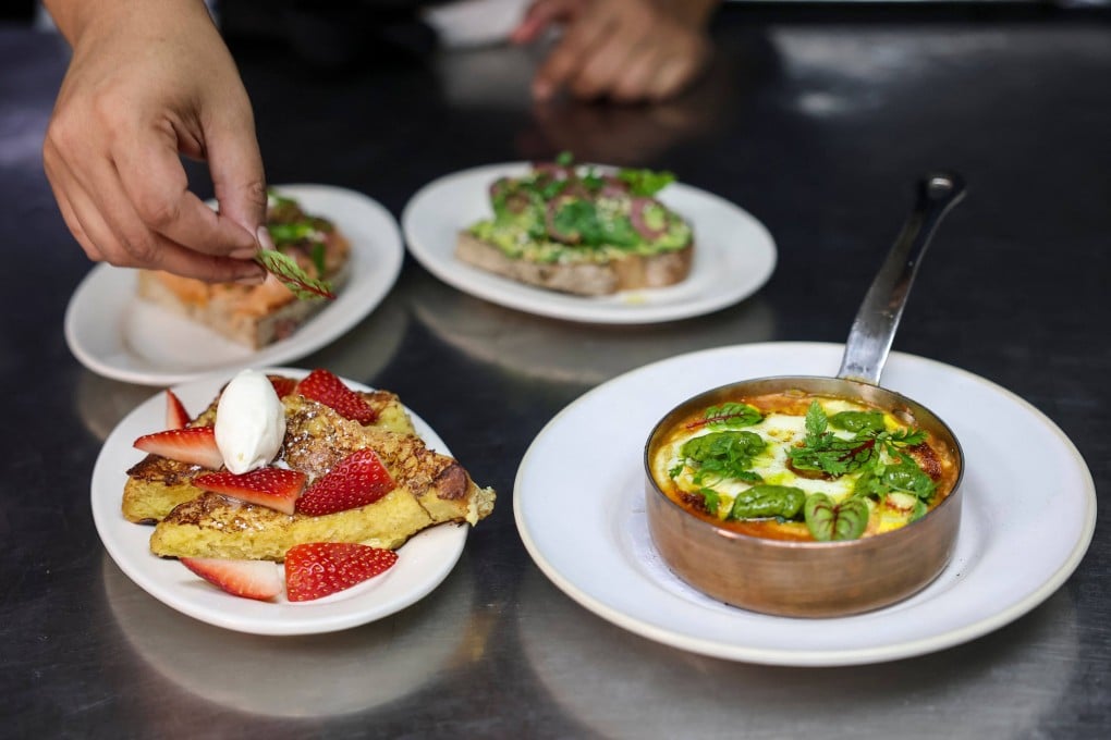 A chef at Le Petit Village in New York prepares half-sized portions of their brunch menu items, designed to appeal to people taking GLP-1 weight-loss medications, on December 10, 2025. Photo: AFP