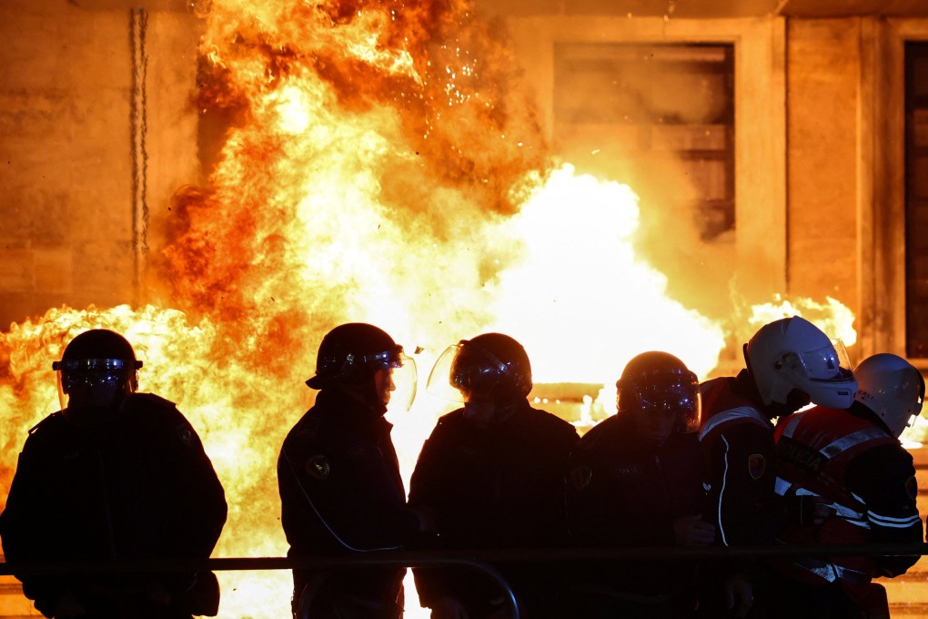 Police officers react to a Molotov cocktail as supporters of the opposition attend an anti-government protest in Tirana, Albania on Monday. Photo: Reuters