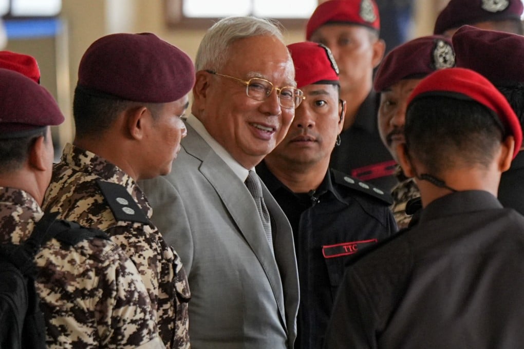 Former Malaysian prime minister Najib Razak escorted by prison officers on his arrival at the Kuala Lumpur High Court Complex on Monday. Photo: AP