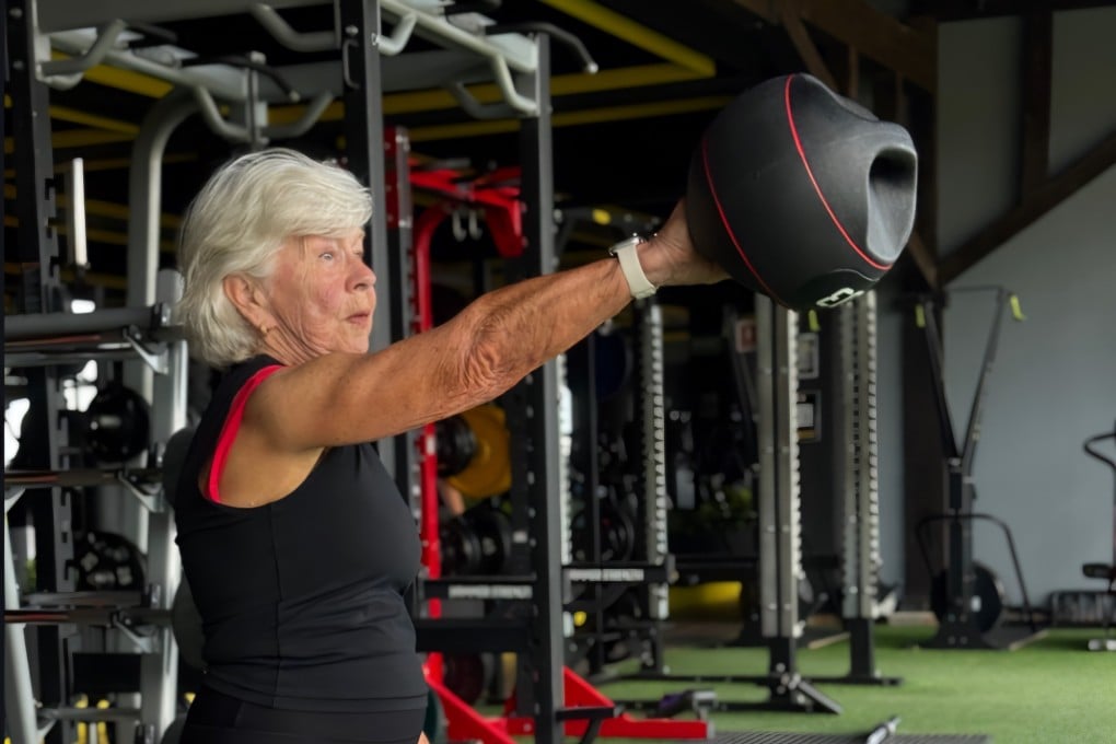 Joan MacDonald, 79, lifts a kettleball as part of a strength training workout to build muscle and bone. Photo: Instagram/trainwithjoan