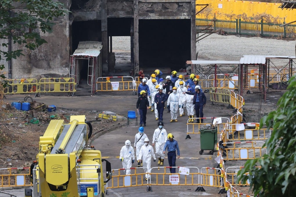 Members of the independent committee inspect Wang Fuk Court in the company of firefighters. Photo: Jelly Tse