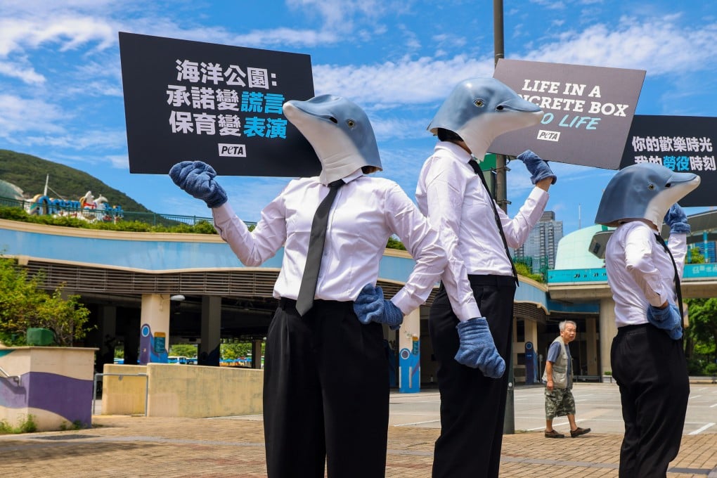 Peta members wearing dolphin masks protest against the Ocean Park’s dolphin shows on August 20. Photo: Nora Tam