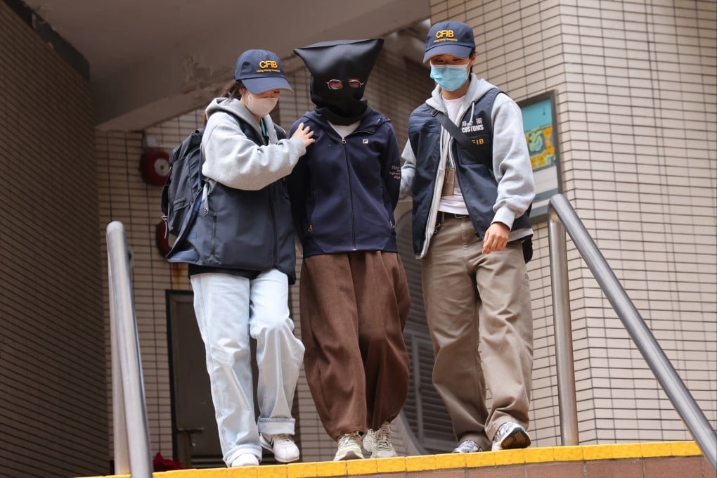 Customs officers arrest one of the suspects involved in the “ghost trading” racket. Photo: Jelly Tse