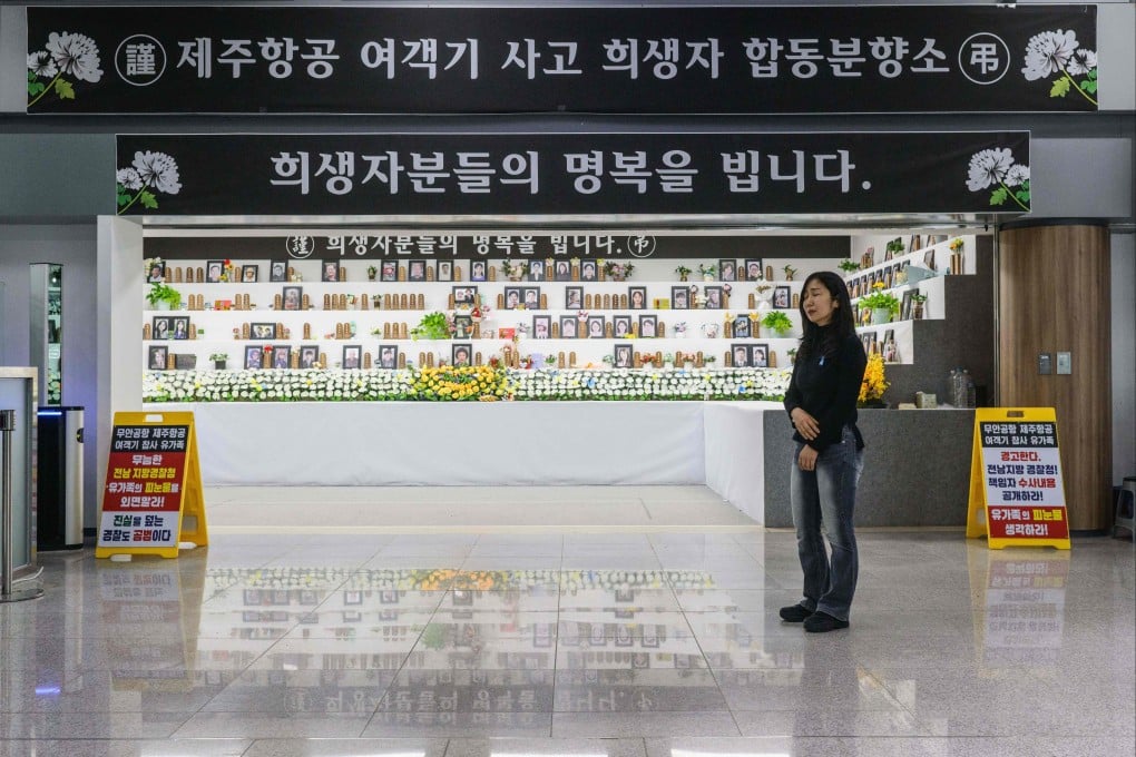 Lee Hyo-eun reacts outside a memorial altar for victims that includes her daughter, who died in last year’s Jeju Air plane crash at South Korea’s Muan International Airport. Photo: AFP