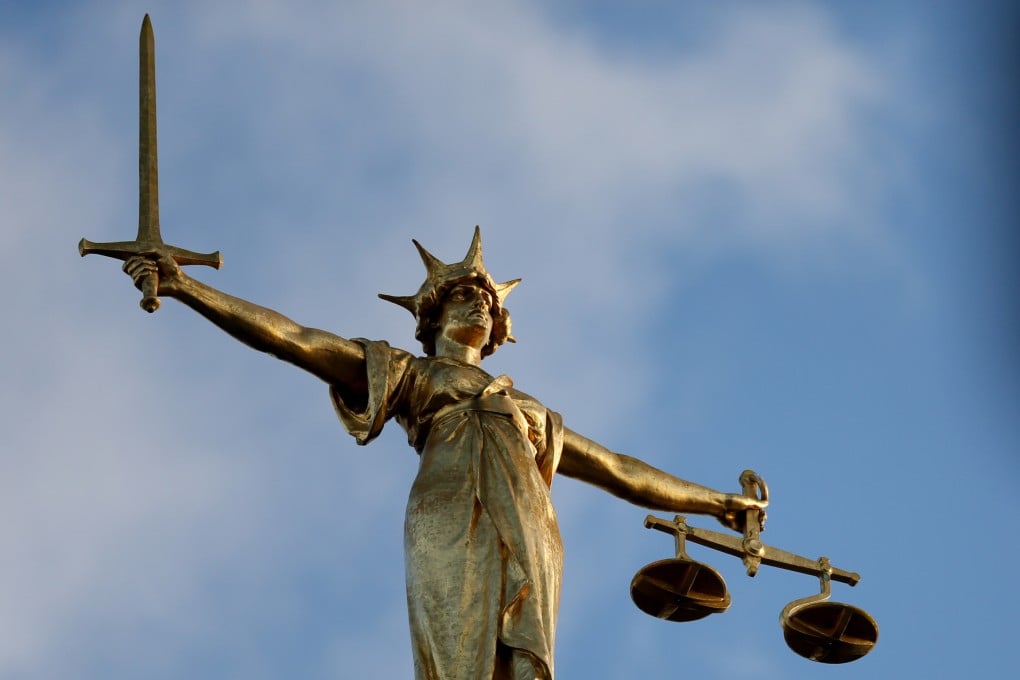 The Statue of Justice atop the Central Criminal Court building in London. Six men have been charged with sexual offences against the same woman. Photo: PA Images via Getty Images