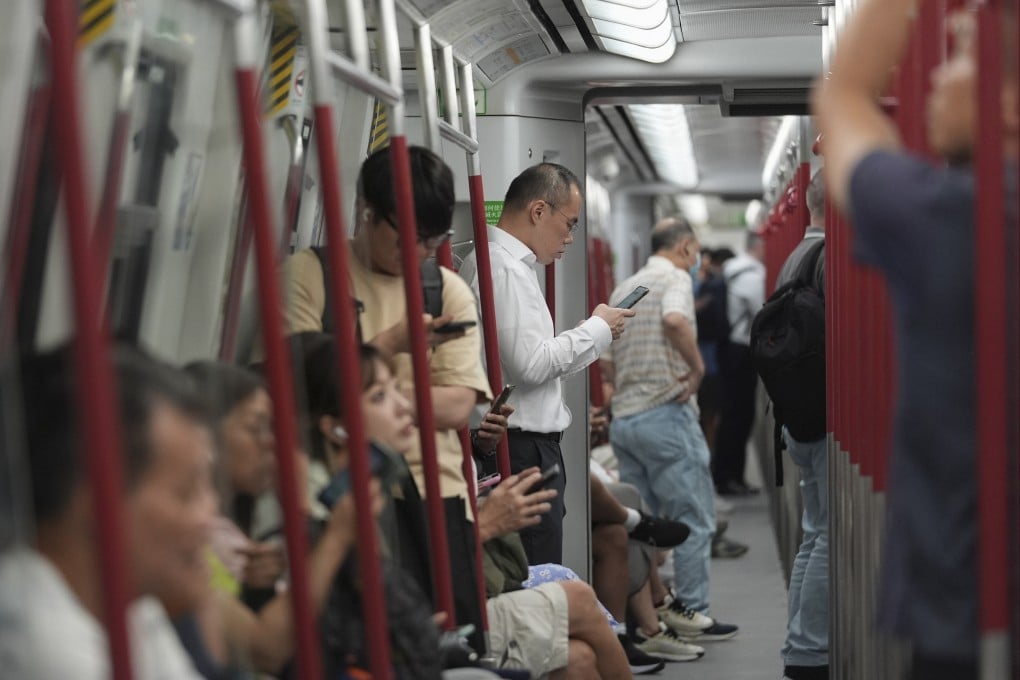 Hongkongers engrossed in their phones are a common sight on the MTR. Photo: Eugene Lee