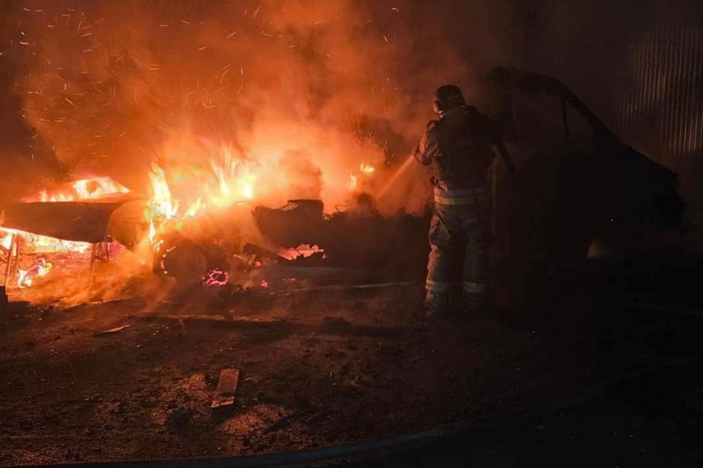A Ukrainian rescuer in the Chernihiv region works to extinguish a fire following the latest drone strikes by Russia. Photo: Handout via AFP
