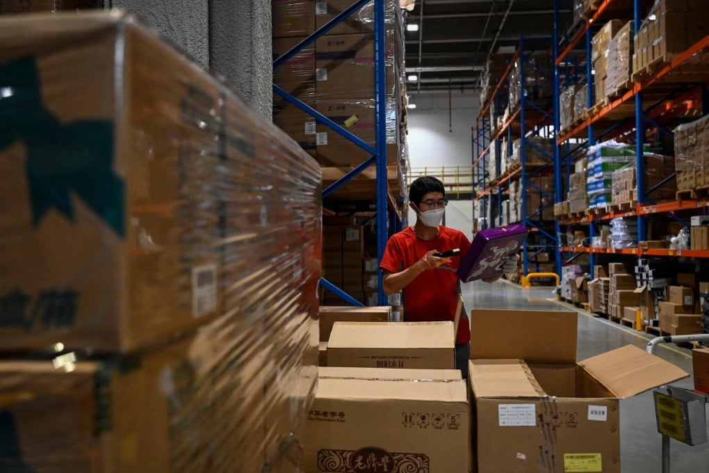 A worker sorts packages for delivery at a JD.com warehouse in Beijing. Photo: AFP